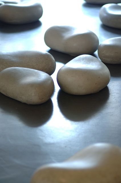 Irene Fortuyn, Buntings made out of newspaper and polished concrete cast stones, Mending Days (Detail), 2007