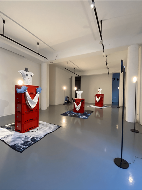 Catherine Biocca, Plasic crates, t-shirts, hand sewn faux-leather hands and handkerchiefs, plastic mannequins, blankets, 4 channel audio installation, loop, 4 min., Cold Comfort, 